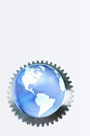 Planet earth in a machine cogの写真素材