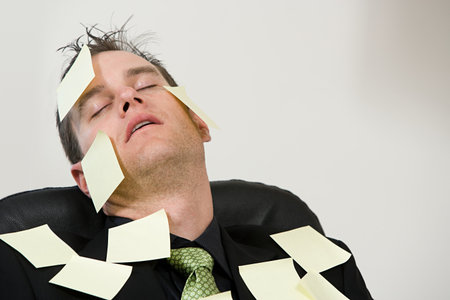 A businessman covered in adhesive notesの写真素材