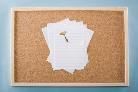 Paper and darts on a noticeboardの写真素材