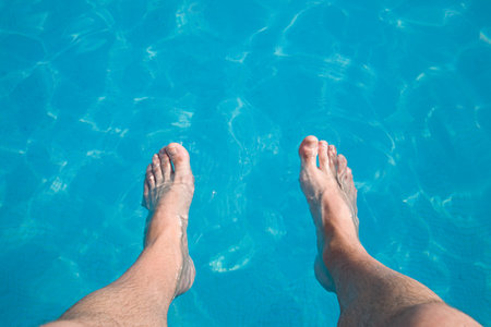 Person with feet in poolの写真素材