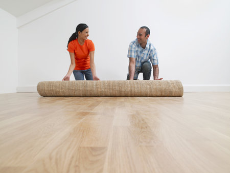 A couple rolling out a rugの写真素材