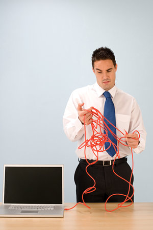 Confused office worker with cableの写真素材