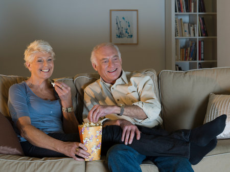 A senior couple watching tvの写真素材