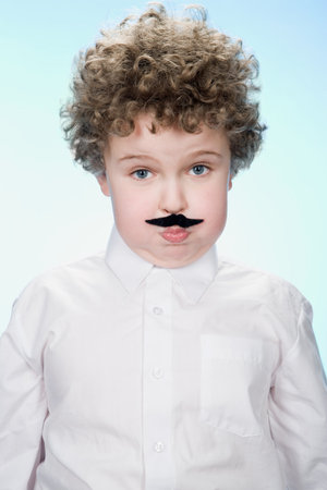 Portrait of a boy wearing a fake moustacheの写真素材
