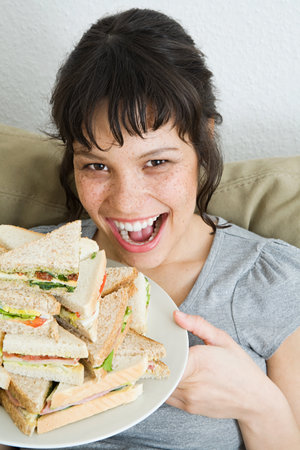 Woman with a stack of sandwichesの写真素材