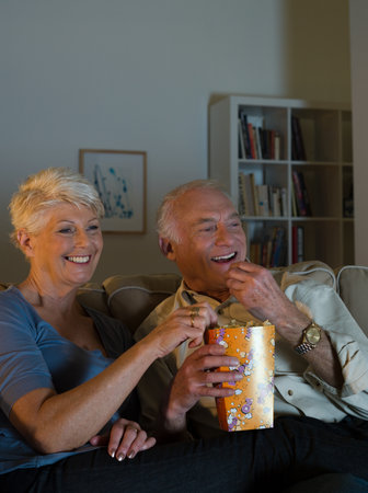 A senior couple watching tvの写真素材