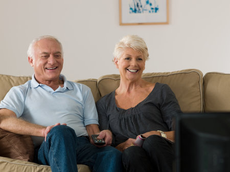 A senior couple watching tv
