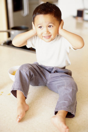 Boy with hands over earsの写真素材