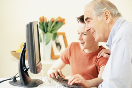 Grandfather and grandson using computerの写真素材