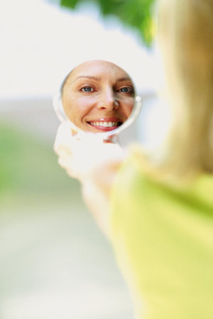 Woman reflected in mirrorの写真素材