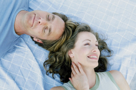 Man and woman lying down togetherの写真素材