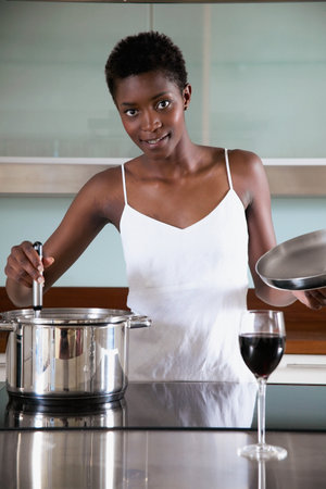 Woman cooking in kitchenの写真素材