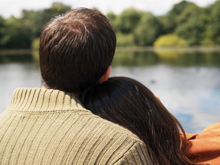Couple sitting near lakeの写真素材