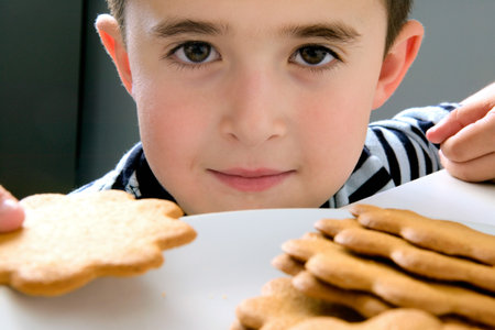 Boy holding a biscuit