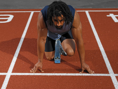 Male sprinter at starting lineの写真素材
