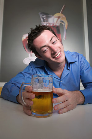 Man looking lovingly at beerの写真素材