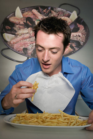 Man eating french friesの写真素材