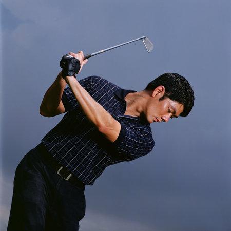 Man swinging golf clubの写真素材
