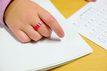 Blind girl reading brailleの写真素材