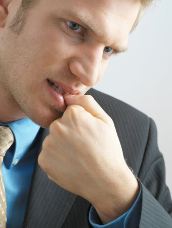 Businessman biting his nailsの写真素材