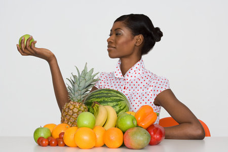 Young woman holding an appleの写真素材