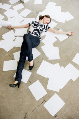 Woman Lying Between Sheets Of Paper