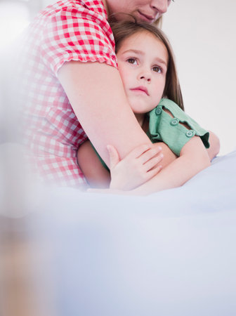 Mother Holding Daughter In Her Armsの写真素材