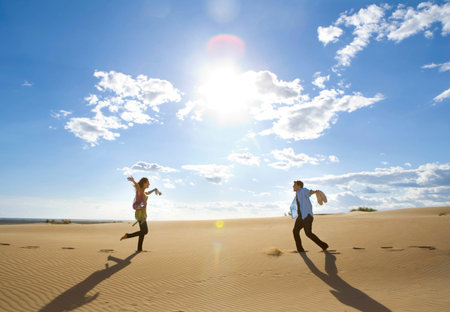Man Finds Woman In Sandの写真素材