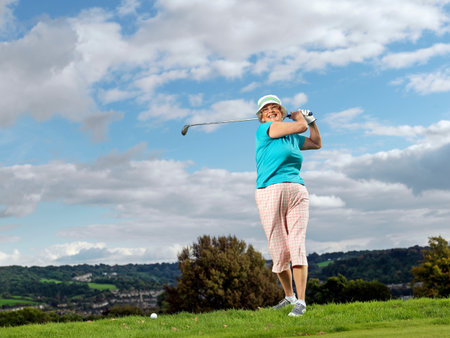Mature Lady Playing Golfの写真素材