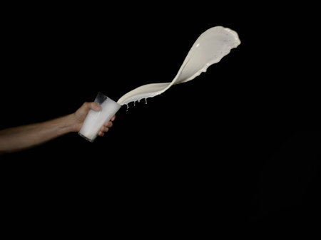 Man Throwing White Liquid From A Glassの写真素材