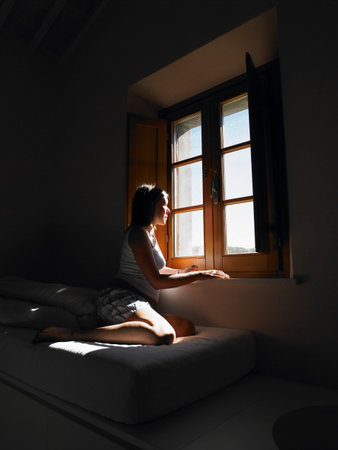 Woman Looking Through Window