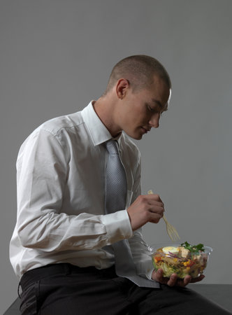 Business Man Eating Saladの写真素材