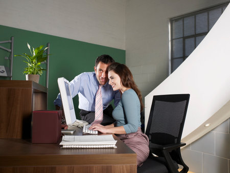 Office Receptionist With Male Workerの写真素材