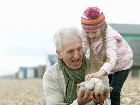 Grandfather And Granddaughter At Beachの写真素材