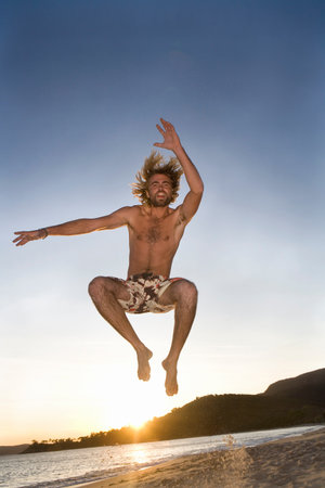 Man Jumps At Beachの写真素材