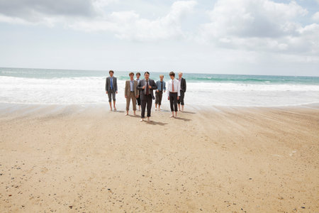 Businessmen Walking On Beachの写真素材