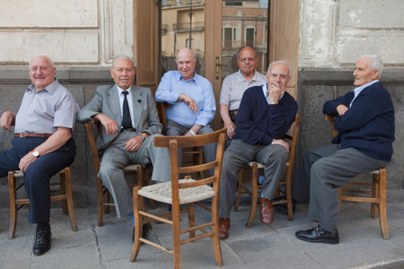 Six Old Men Sitting Outside On Chairsの写真素材