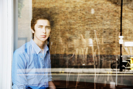 Teenage Boy Looking Out Window