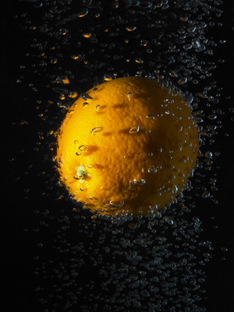 Orange In Bubbles, Black Backgroundの写真素材