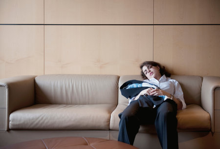 Businesswoman Sleeping On Couchの写真素材