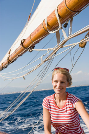 Woman Sitting On A Sailing Boatの写真素材