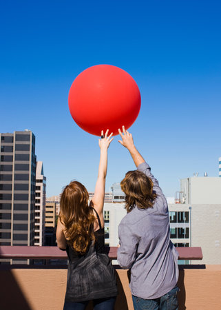 Friends On Roof Top With Red Balloonの写真素材