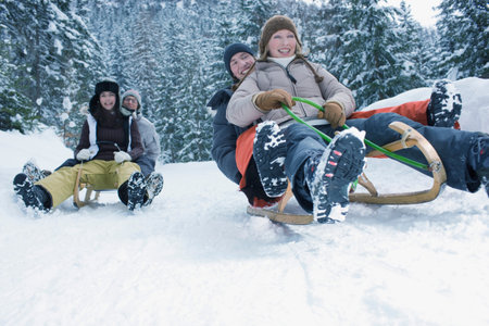 Teenagers Riding Sled In The Snow