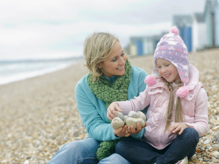 Mother And Daughter Together On Beachの写真素材