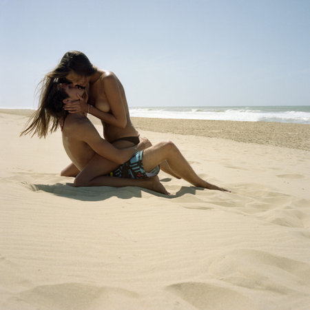 Couple Kissing On Empty Beachの写真素材