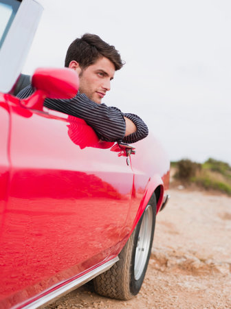 Man Leaning Out Of An Open-Topped Carの写真素材