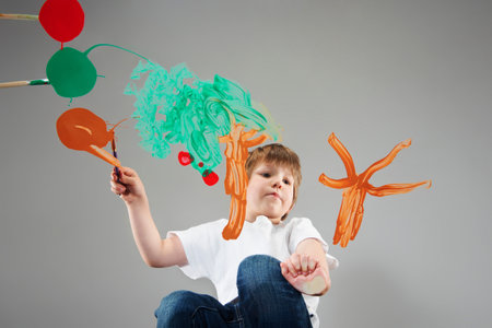 Boy Painting Trees On Glassの写真素材
