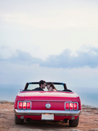 Couple Sitting In Front Of Cabrioletの写真素材