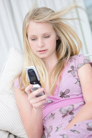 Teenage Girl Using Mobile Phoneの写真素材