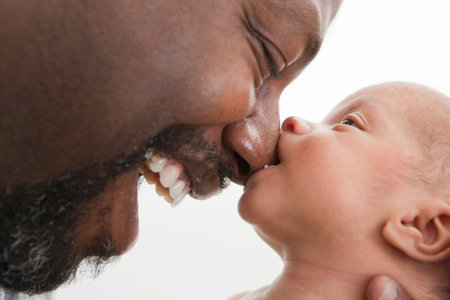 Baby Biting Nose Of Laughing Fatherの写真素材
